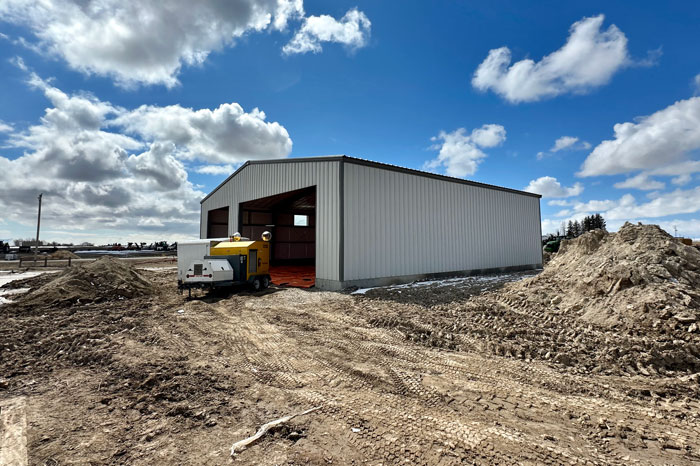 steel building unfinished on construction site