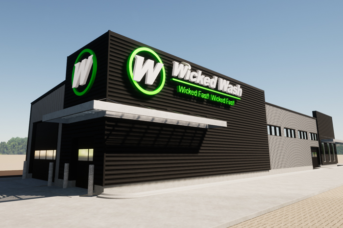 under construction steel structure with roof and supports over snowy ground